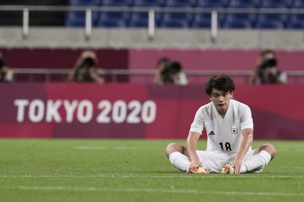 Japan's Ayase Ueda sits after losing 1-3 against Mexico the men's bronze medal soccer match at the 2020 Summer Olympics, Friday, Aug. 6, 2021, in Saitama, Japan. (AP Photo/Martin Mejia)
